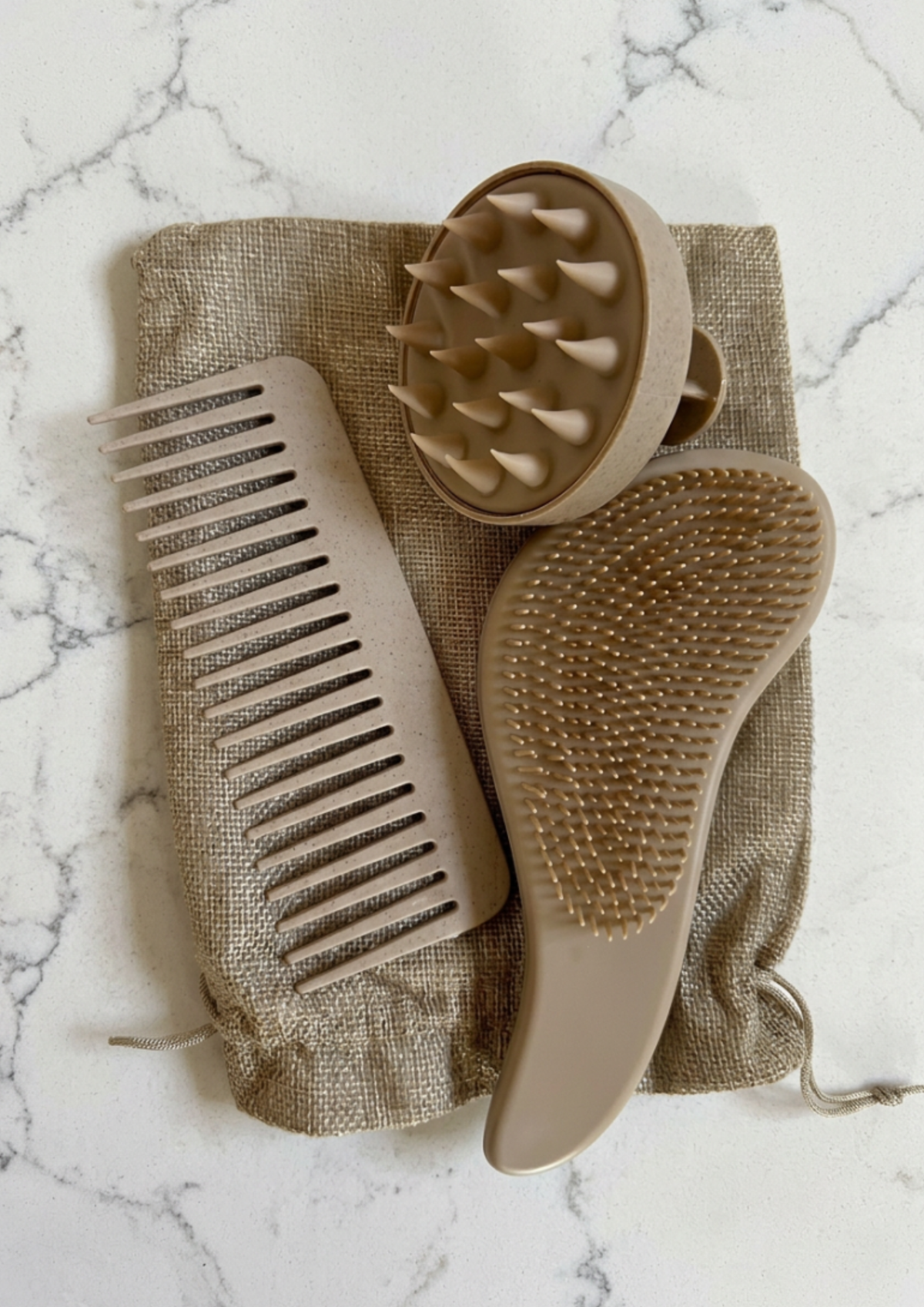 Purely Her Sanctuary 5-Piece Hair Care Set in beige with comb, shampoo brush and detangling brush on a burlap gift bag