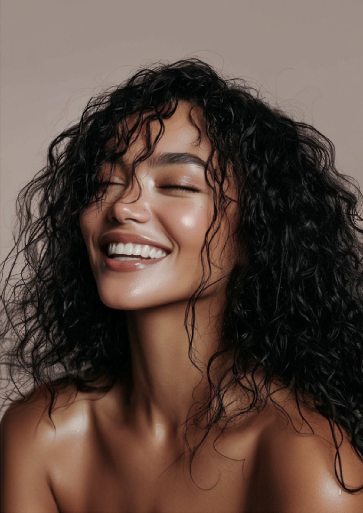 A smiling woman with dark curly hair